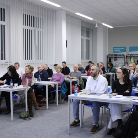Audience at public dialogue on Dec. 9, 2025